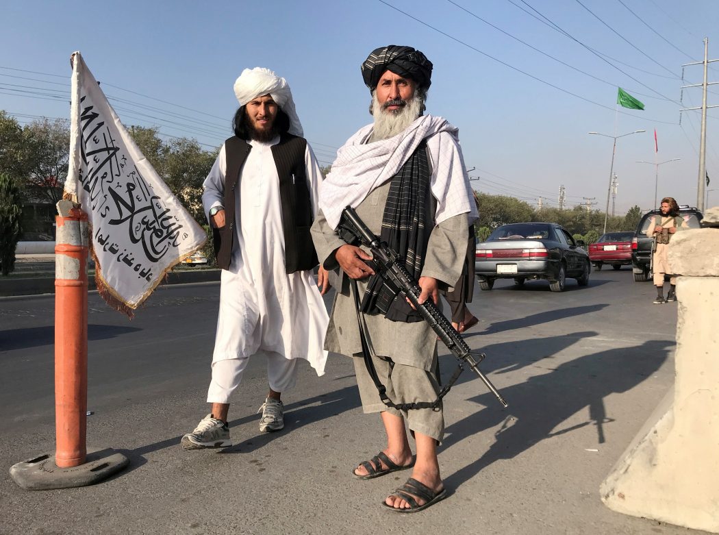 FILE PHOTO: Taliban fighter stand outside the Interior Ministry in Kabul
